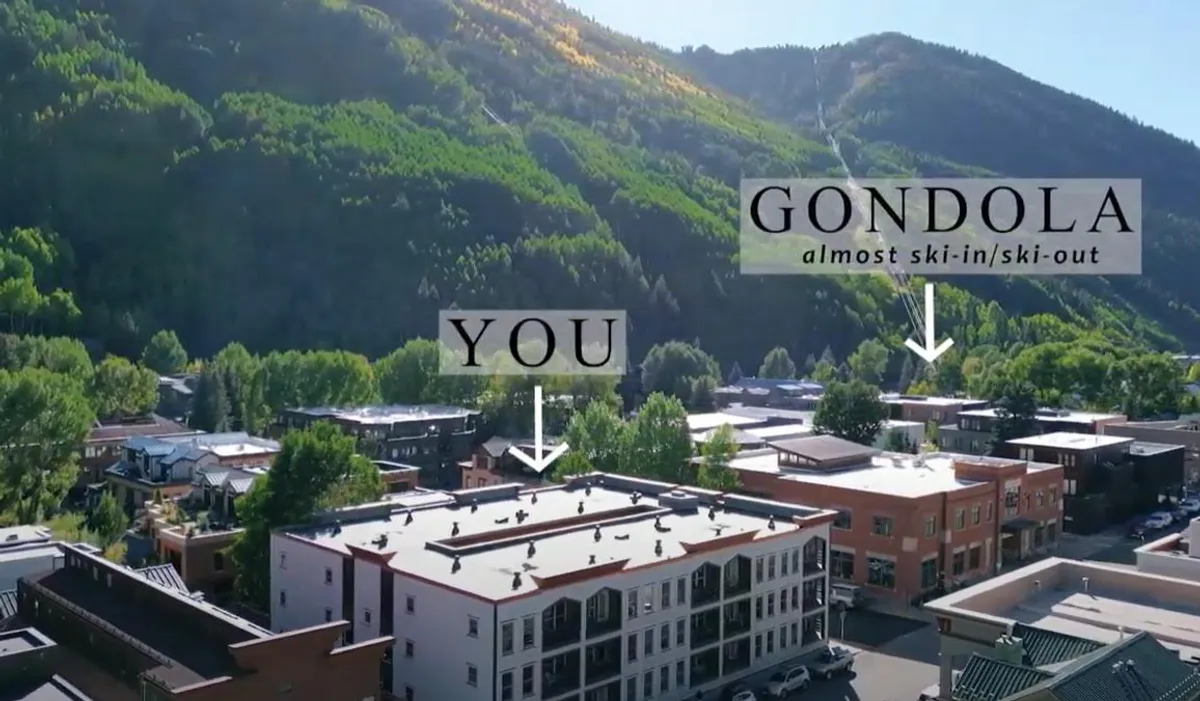 An engaging exterior view featuring the Telluride gondola, surrounding mountains, and iconic town buildings, capturing the essence of ski-in/ski-out convenience and proximity to trails and attractions.